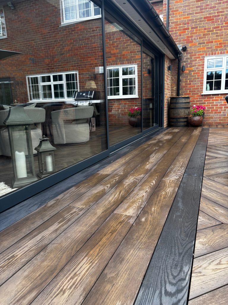 Millboard Antiqued deck with Burnt Cedar trim designed by Karl Harrison