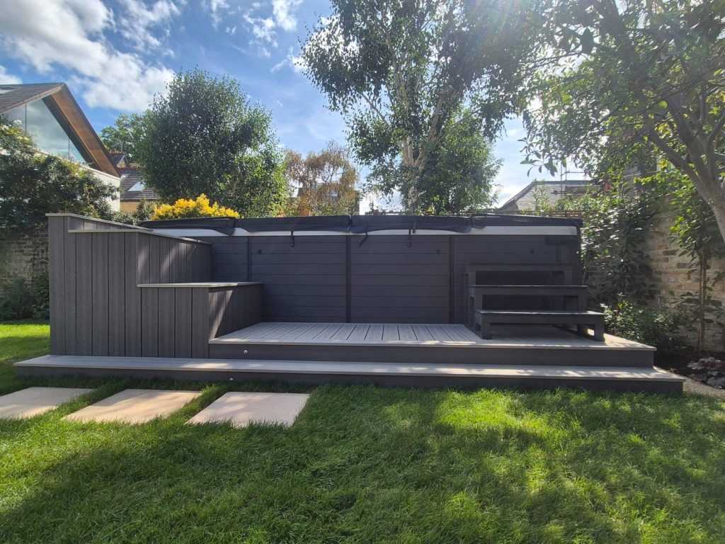 A simple decking platform next to a swim spa